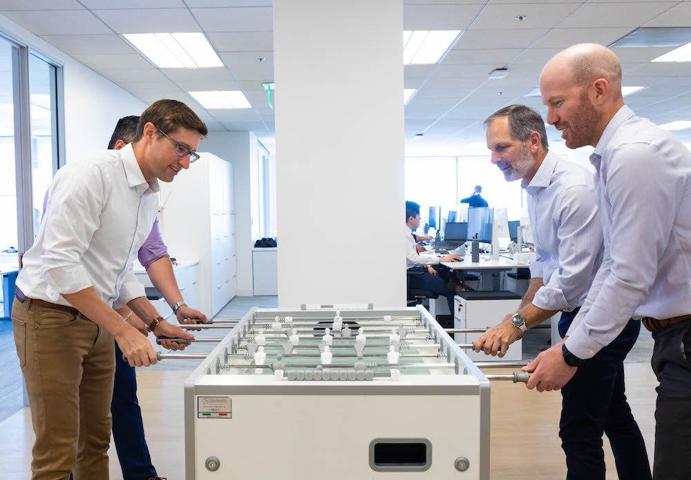 Adapture office playing foosball