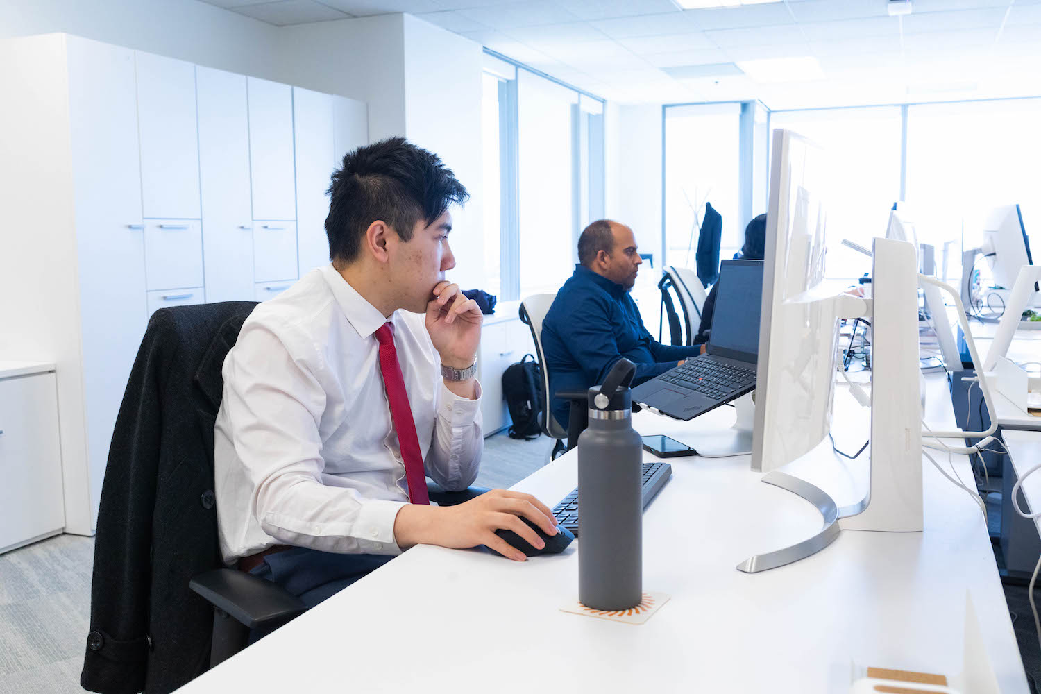 Adapture offices desk shot of employees working